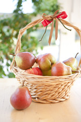 Basket with ripe pears and glasses with pear schnapps