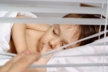 Amusing little girl sleeping at home