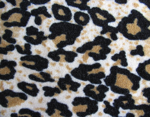 Fleecy white and brown leopard skin fabric background