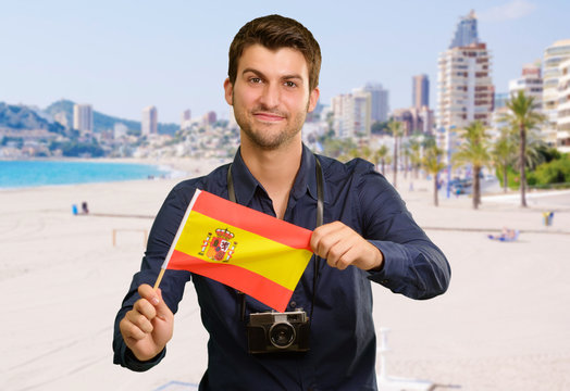 Portrait of a young man holding a flag