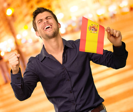 Man holding a flag and cheering