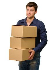 A Young Man Holding A Stack Of Cardboard Boxes