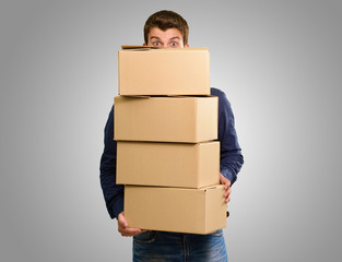 Man holding cardboard boxes - obrazy, fototapety, plakaty