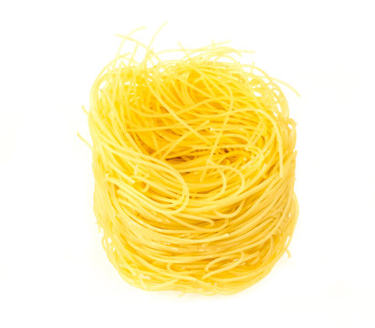 A portion of tagliatelle italian pasta isolated on white