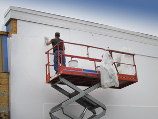 Contractor plasterer finishing a commercial building