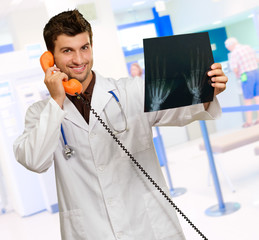 Portrait Of A Doctor Holding Phone And X-ray