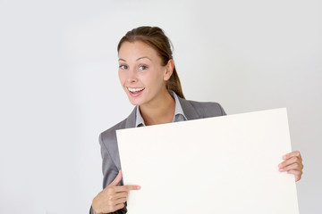 Fototapeta premium Businesswoman holding whiteboard with texspace