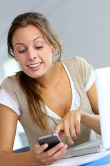Young woman happy to read message on telephone
