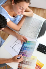 Upper view of couple looking at colour chart