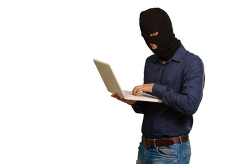 young male thief holding laptop