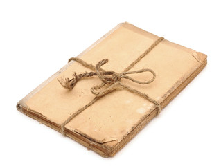Old book tied up by a rope isolated on a white background