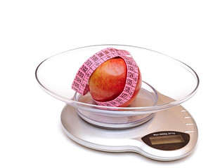 red apple on a scale and measuring tape