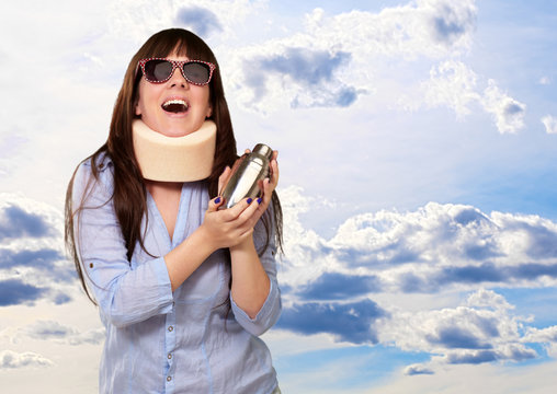 Woman Wearing Neckbrace Holding A Shaker