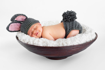 smiling newborn baby boy wearing a gray bunny rabbit costume