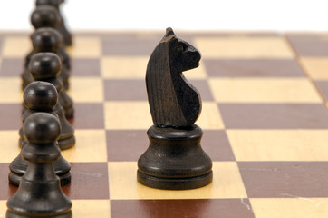 Knight stand in front of all pawn chess line board