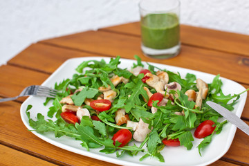 Fresh salad with rucola tomatoes and chicken breast