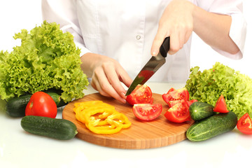 woman hands cutting vegetables on kitchen blackboard