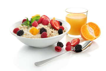tasty oatmeal with berries and glass of juice, isolated on