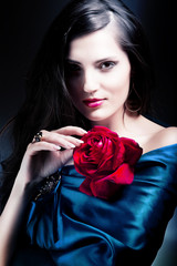 beautiful woman in blue fabric with red rose