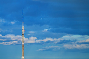 television tower with deep blue cloudy afternoon sky