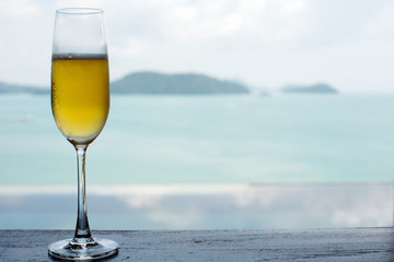 A glass of beer with sea background