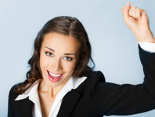 Fototapeta premium Happy gesturing business woman, over blue