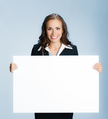 Businesswoman showing signboard, over blue