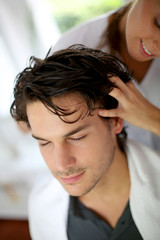Hairdresser doing hair massage to customer © goodluz