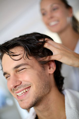 Hairdresser doing hair massage to customer