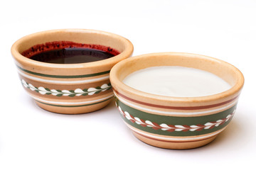 sour cream and cherry jam in the ceramic bowl