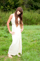 Fototapeta na wymiar Teenage girl in a white dress on the nature