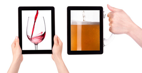 Obraz na płótnie Canvas Hands Holding Digital Tablet with Red wine and beer