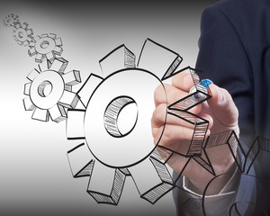 Business man drawing gear to success