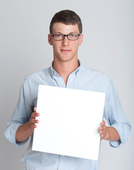 Young man holding a blank sign