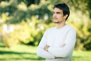 Handsome man outdoors in fall clothing looking to the side