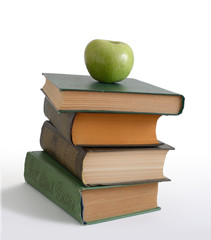 green apple on a books