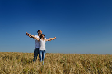 happy couple in wheat field