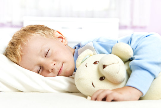Small Child Sleeping In Bed