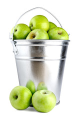 Green apples in bucket isolated on white background