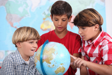 Three kids learning geography.