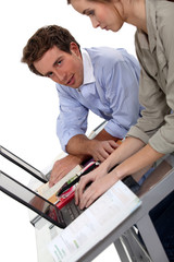 male and female colleagues working on laptop