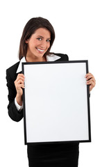 Smart young woman holding a blank board ready for your text