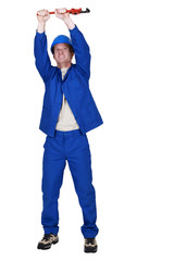 Plumber raising wrench above head