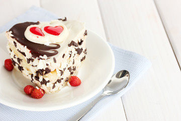sweet cake with chocolate on plate on wooden table