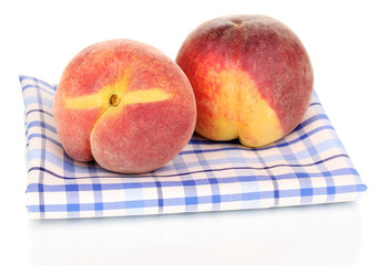 ripe peaches on napkin isolated on white.