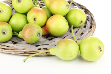 ripe pears on wicker mat isolated on white.