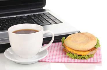 Eating at work place near laptop