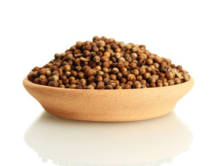 Heap coriander seeds in clay bowl isolated on white