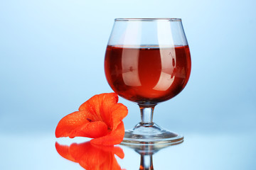 glass with cocktail and gladiolus bud
