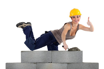 Pirouetting female mason behind wall © auremar